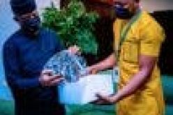Osinbajo encourages Nigerian shoemaker, wears his product