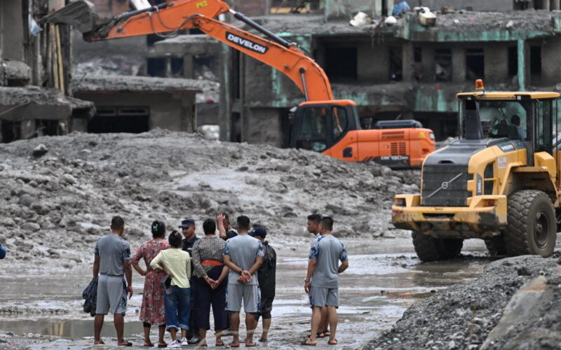 Rescuers claw through mud as Nepal, China flood missing toll nears 3,000
